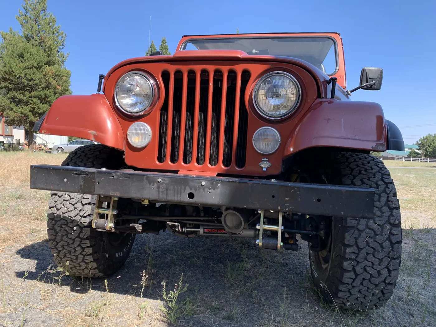Front of a red 1979 Jeep CJ5 with off-road tires